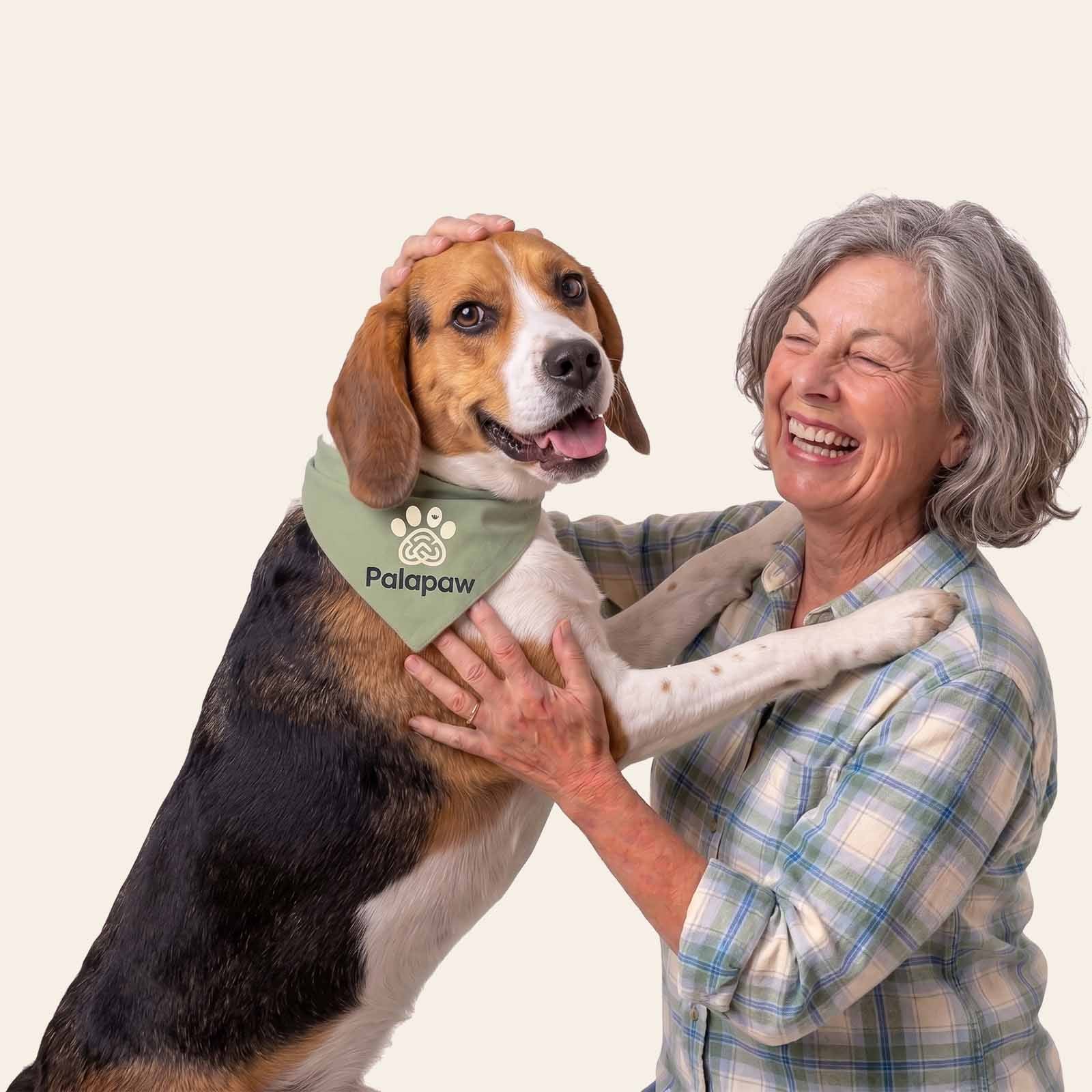 Woman holding a dog wearing a Palpaw bandana on a white background